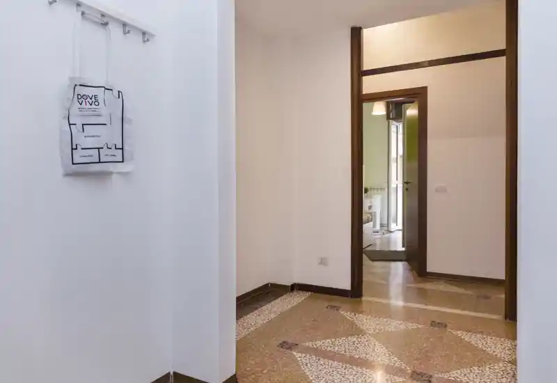 Bright, clean entrance hall with decorative terrazzo flooring, white walls and a view through to adjoining rooms — ideal first impression for a rental listing.