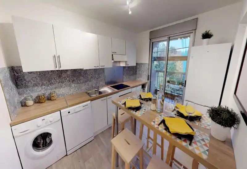 Bright, modern kitchen with wooden countertops, patterned backsplash and a breakfast bar set for four; large window/door opens to a small balcony bringing natural light.