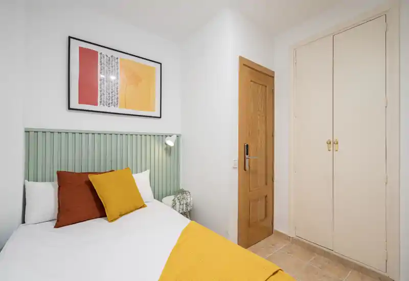 Image corrupted with strong horizontal green artifacts; room contents are not identifiable.