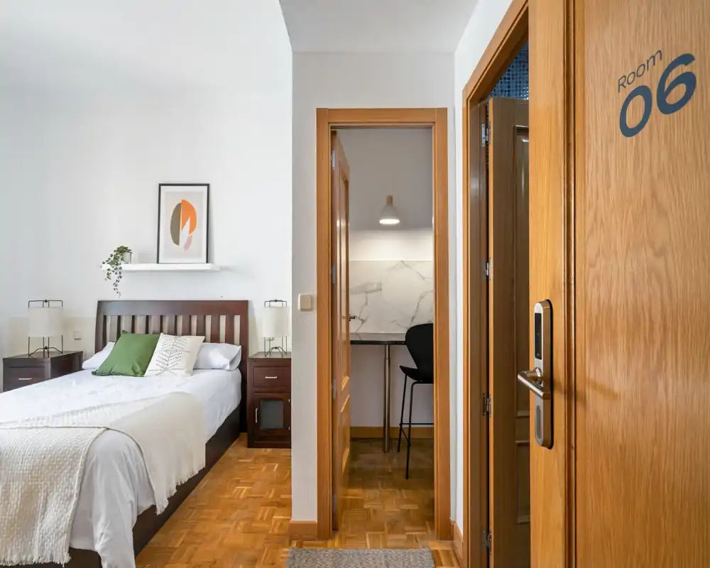 Bright, well-staged bedroom with a full bed, bedside tables and tasteful decor — ideal for rental photos emphasizing comfort and cleanliness.