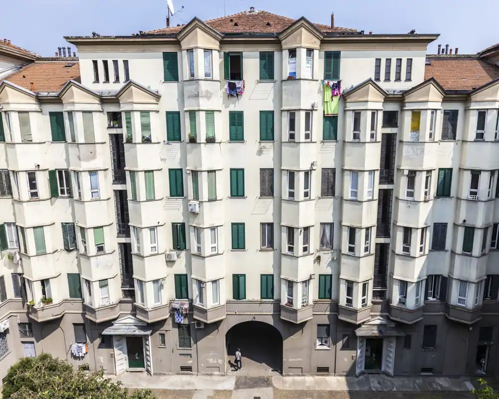 Exterior view of an apartment building facade with multiple windows and balconies; the photograph shows the building frontage rather than any interior room.