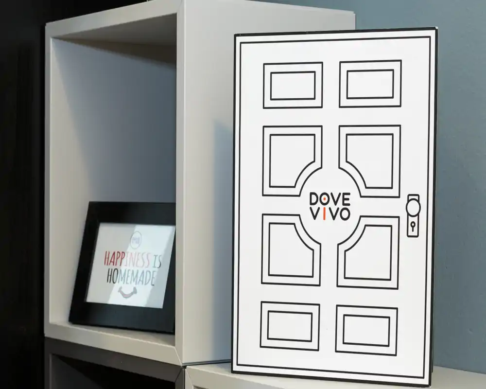 Close-up of a shelf with decorative signage and a framed print reading "Happiness is Homemade" — a detail shot rather than a photograph of a specific room.