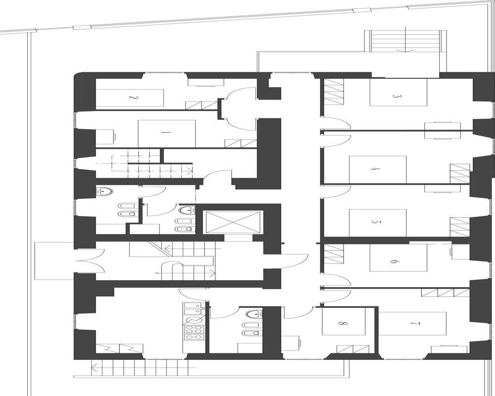 Architectural floor plan drawing showing layout of multiple rooms, corridors, stairs and sanitary areas — a top-down plan view useful for understanding apartment arrangement.
