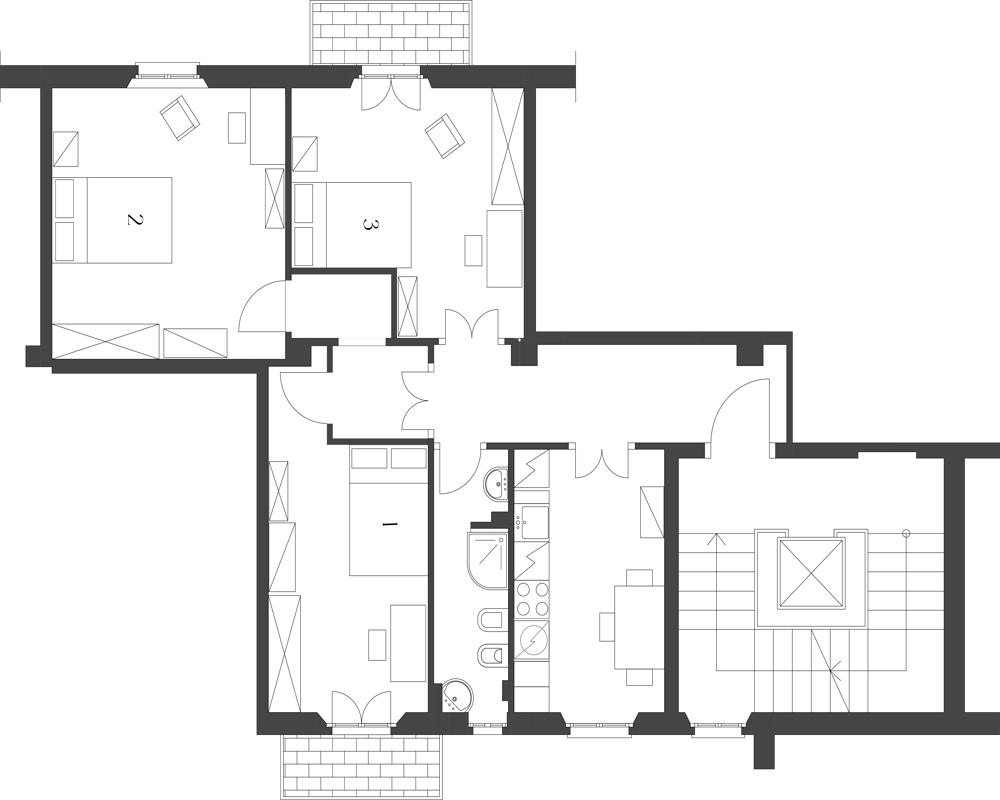 Pianta architettonica (planimetria) che mostra la disposizione di più ambienti tra cui camere, bagno, cucina e aree di circolazione.