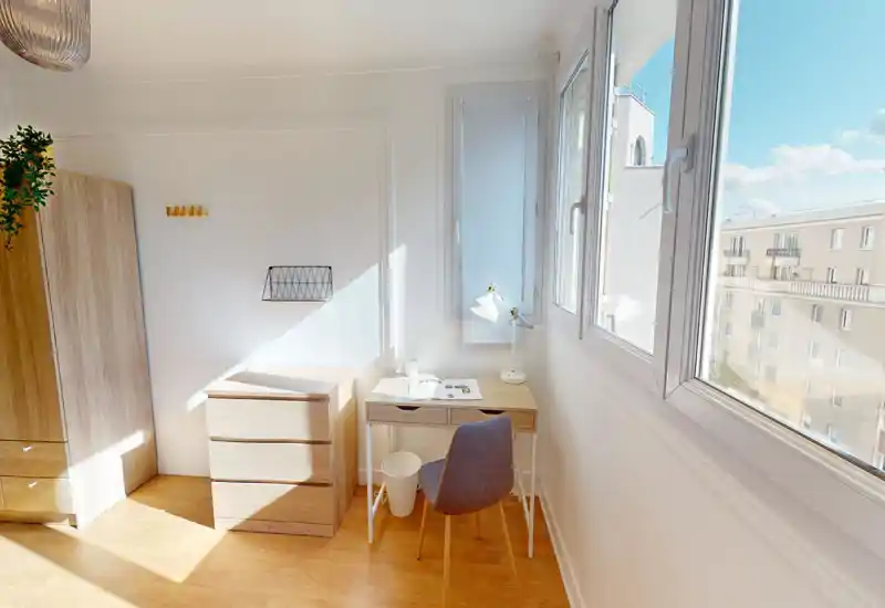 Bright, minimalist bedroom corner with light wood wardrobe and chest of drawers next to a compact desk by large windows offering abundant natural light.