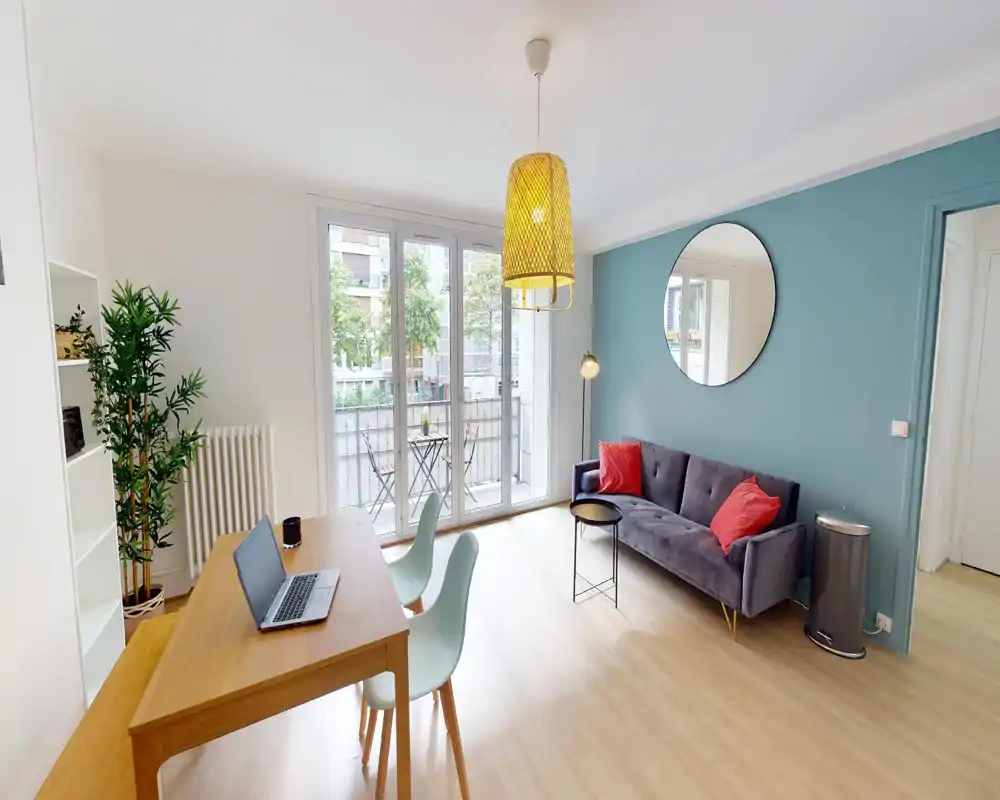 Bright living area with a comfy armchair, cushions and potted plants; modern, relaxed layout ideal for a rental listing.