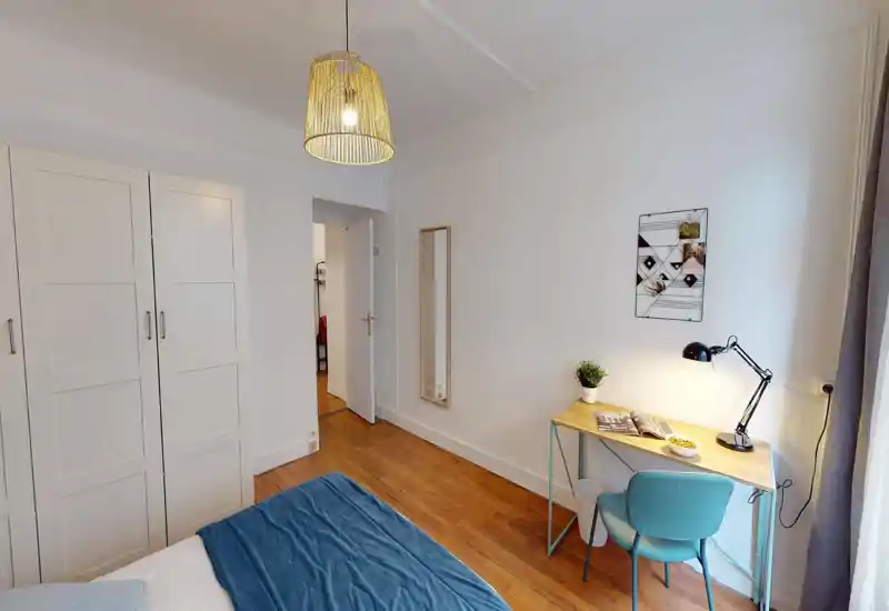 Bright, neatly styled bedroom with a visible bed, wardrobe and a small work desk by the window—ideal for single occupancy or a cosy rental stay.