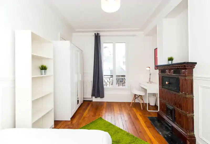 Unable to generate a reliable room description: the photo is severely corrupted and pixelated, making furniture and room features unrecognizable. Please provide a clearer image showing the room's main elements.