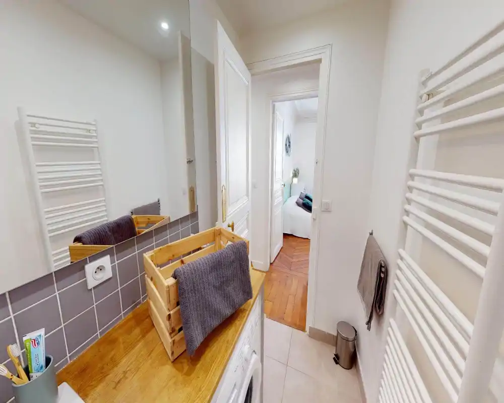 Corrupted but appears to show a bedroom area with a bed or mattress and soft textiles; image is heavily distorted and details are limited.