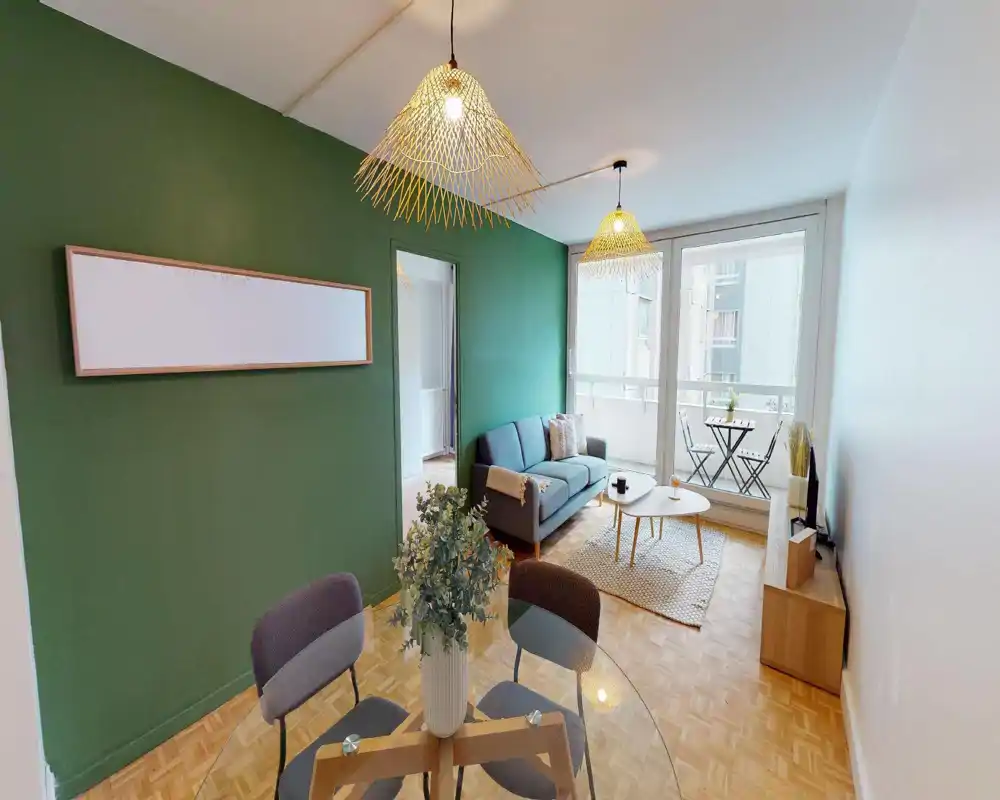 Bright, stylish living room with a compact sofa, coffee table and balcony access; warm pendant lights and coordinated decor create an inviting space.