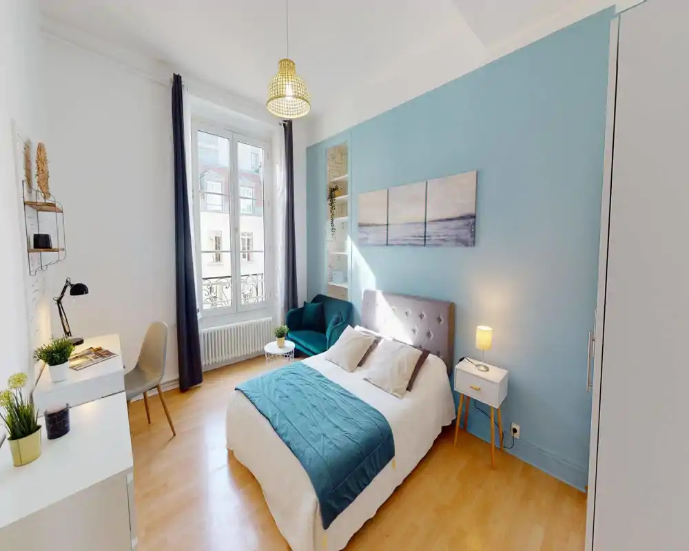 Bright, modern bedroom with a made bed, decorative cushions and bedside tables; image has strong digital artifacts but shows a cozy sleeping area.