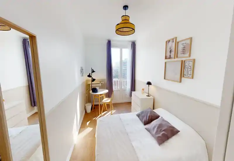 Bright, well-styled bedroom with a comfortable double bed, soft textiles and natural light from the balcony doors — ideal for restful stays.