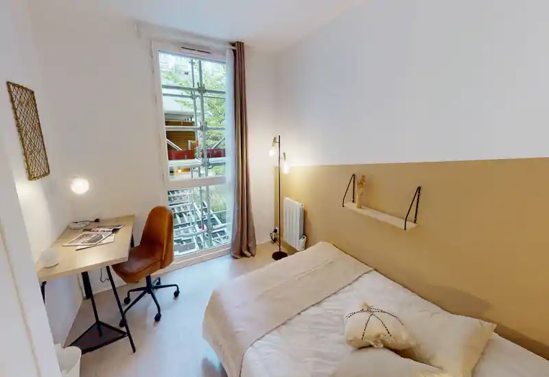 Camera singola luminosa e ben arredata con letto confortevole, tessili caldi e una piccola scrivania vicino alla finestra — ideale per uno studente o una persona sola.