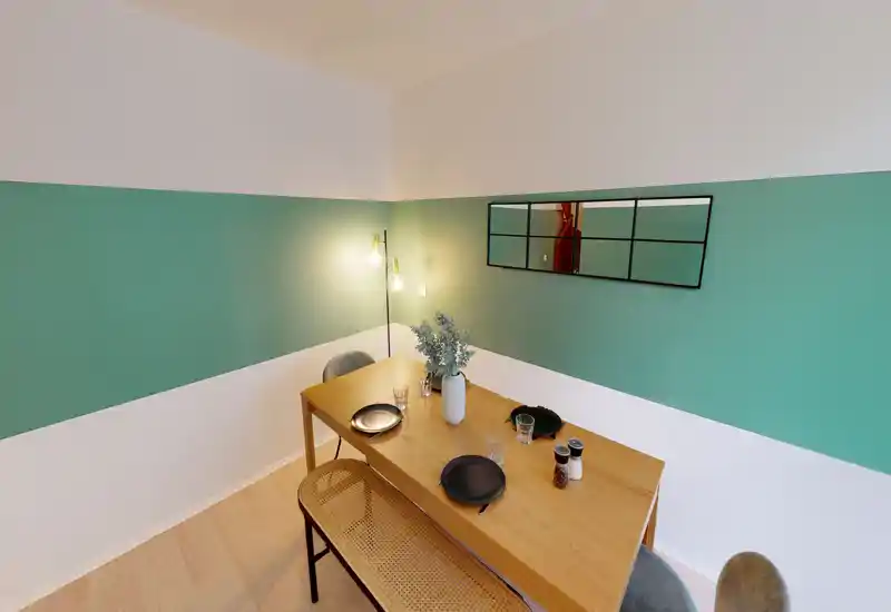 Bright, modern dining area with a wooden table set for four, warm lighting and decorative vase—suitable for cozy meals.