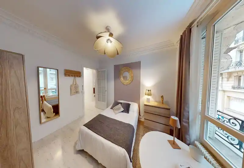 Sunny, well-styled single bedroom with a comfortable bed, bedside dresser and large window letting in abundant natural light.