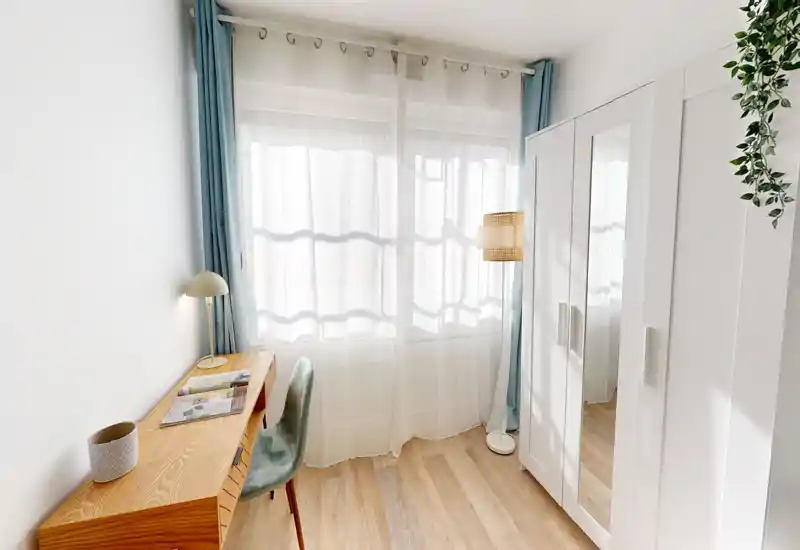 Bright, minimal bedroom corner with a desk, wardrobe with mirrored door and soft curtains that let in abundant natural light.