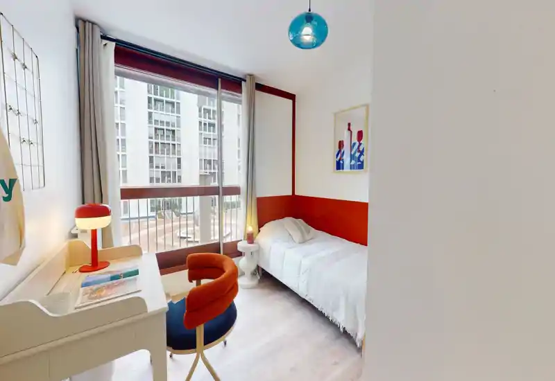 Bright, well-staged single bedroom with a comfortable bed, desk and large window that floods the room with natural light.