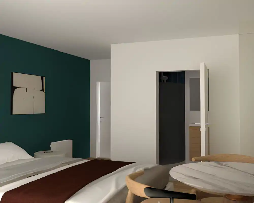 Dormitorio moderno con luz suave y una cama grande en primer plano, pared de acento verde, mesita y una pequeña mesa redonda con sillas — un área de descanso acogedora y contemporánea.