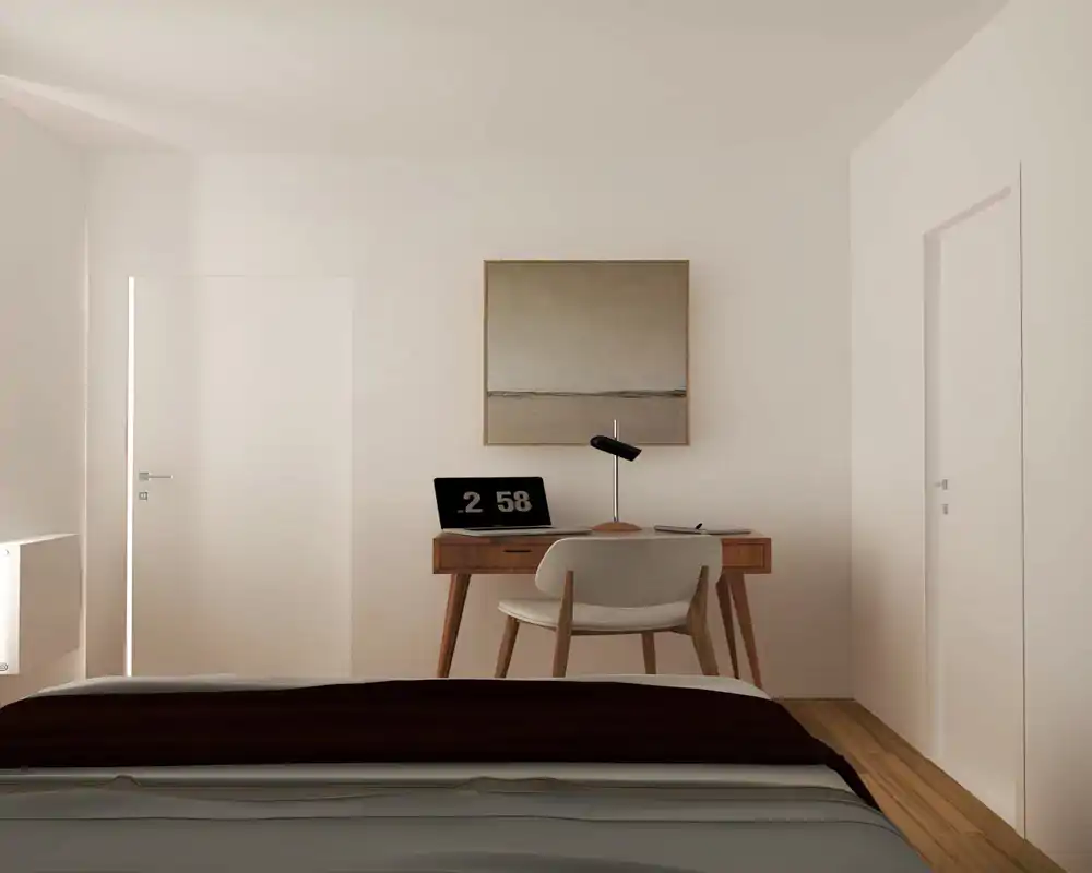 Chambre lumineuse et minimaliste avec le lit au premier plan et un petit bureau en bois contre le mur arrière. Tons neutres et chaleureux, chaise simple, lampe de bureau et tableau encadré pour une ambiance contemporaine et apaisante.